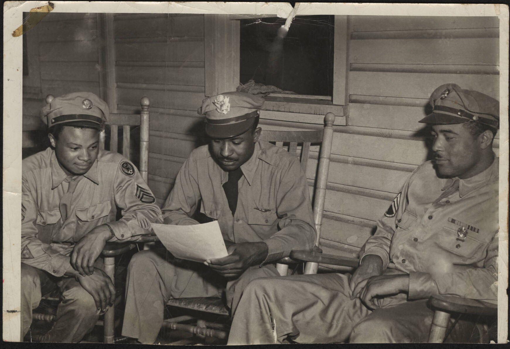 Three Black officers seated in the 1950s